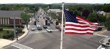 view of crawford square with traffic and American Flag from stetson hall