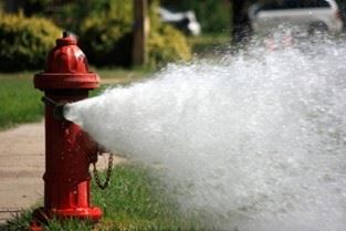 fire hydrant with water being flushed out of it